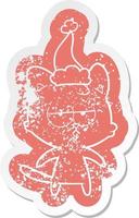 bored cartoon distressed sticker of a cat wearing santa hat vector