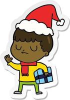 sticker cartoon of a grumpy boy wearing santa hat vector