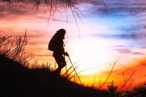 Girl hiking in silhouette photo