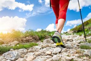 Nordic walking uphill on the mountain path photo