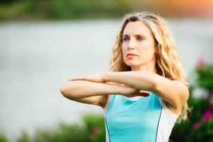 Yoga. Young woman doing yoga exercise outdoor photo