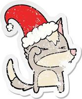 distressed sticker of a tired wolf cartoon wearing xmas hat vector