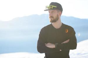 Man with beard in the wilds observes nature photo