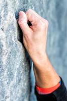 hands climbing on the rock photo