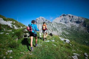 Trekking of two coworkers working in the mountains on a day off photo