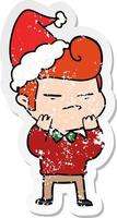 distressed sticker cartoon of a cool guy with fashion hair cut wearing santa hat