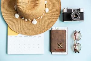 Travel items and calendar on color background with copy space, Vacation planning concept photo