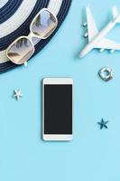 Travel accessories items with smartphone on color background and copy space, Summer vacation concept photo