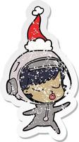 distressed sticker cartoon of a pretty astronaut girl wearing santa hat vector