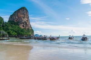 Beautiful tropical railay beach with Thai traditional wooden longtail boat at Krabi, Thailand photo