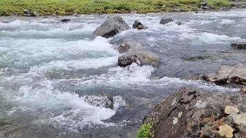 Fantastic landscape with flowing rivers and streams with rocks and grass in Iceland. video