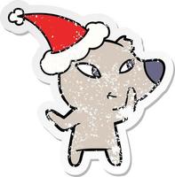 cute distressed sticker cartoon of a bear wearing santa hat vector