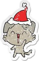 happy little dog distressed sticker cartoon of a wearing santa hat vector