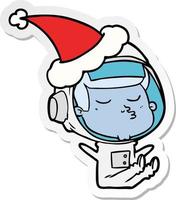 sticker cartoon of a confident astronaut wearing santa hat vector