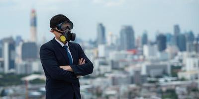 portrait of businessman wearing gas pollution protection face mask and suit, concept of danger toxic safety for human and chemical environment problem man about hazard business photo