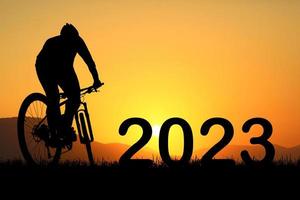 Mountain Biker Silhouette and Happy New Year 2023 photo