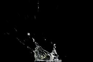 Water splashing on a black background. abstract background of water diffused on black background photo