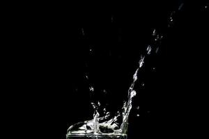 Water splashing on a black background. abstract background of water diffused on black background photo