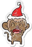 shouting distressed sticker cartoon of a monkey wearing santa hat vector