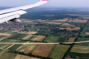 The earth is visible through the window of an airplane photo