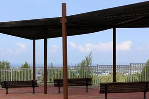 Bench for rest in a city park on the shores of the Mediterranean Sea. photo