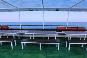 Bench for rest in a city park on the Mediterranean coast in northern Israel photo