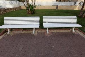 Bench for rest in a city park on the Mediterranean coast in northern Israel photo