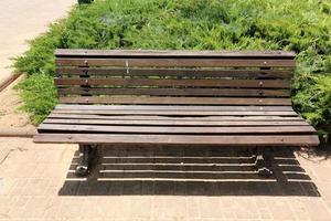Bench for rest in a city park on the Mediterranean coast in northern Israel photo