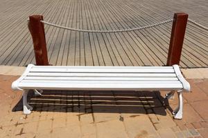 Bench for rest in a city park on the Mediterranean coast in northern Israel photo