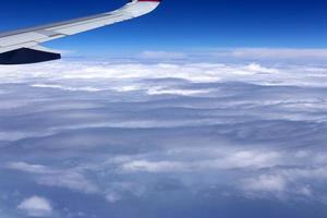 The earth is visible through the window of an airplane photo