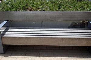 Bench for rest in a city park on the Mediterranean coast in northern Israel photo