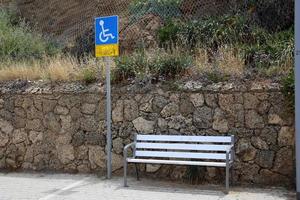 Bench for rest in a city park on the Mediterranean coast in northern Israel photo