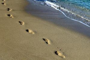 Footprints in the sand on the shores of the Mediterranean Sea in northern Israel photo