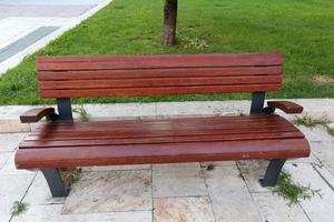 Bench for rest in a city park on the shores of the Mediterranean Sea. photo