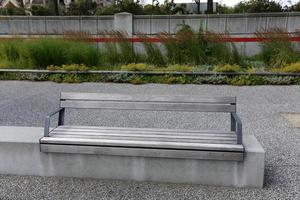 Bench for rest in a city park on the shores of the Mediterranean Sea. photo