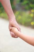 Family support - father hold child hand with love photo