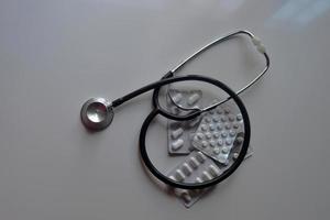 Medical stethoscope and medicines photo