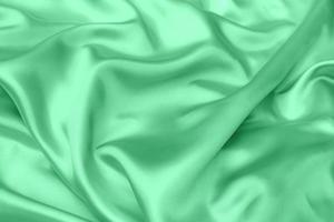 green satin fabric texture soft blur background photo