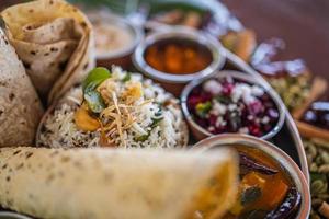 Indian food Curry butter chicken, Palak Paneer, Chiken Tikka, Biryani, Vegetable Curry, Papad, Dal, Palak Sabji, Jira Alu, Rice with Saffron on dark background photo