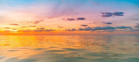 Sunset sea seascape. Colorful ocean beach sunrise. Beautiful beach scenery with calm waves and soft sandy beach. Empty tropical landscape, horizon with scenic coast view. Colorful nature sea sky photo