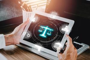 Justice and law concept, Male judge working on tablet computer with VR screen law icon background. photo