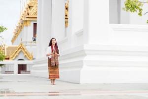 Asia woman wearing traditional dress of Thailand praying in church photo