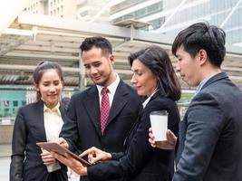 Caucasian and Asian business group happy and smiling after successful to find business data photo