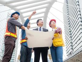 Group of engineer team and businessman at construction site and discussion with their project work photo