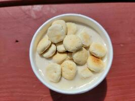 bowl or cup of clam chowder on red table photo