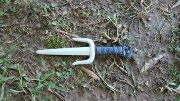 plastic martial arts sai weapon on ground or lawn photo