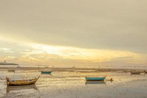 Beautiful sunset scenic of boat parking into the sea mud at Bang Lamung, Pattaya, Chonburi, Thailand photo