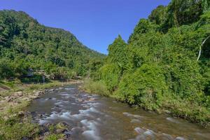 Water flow from the river in the countryside hometown at Sapun village, Nan, Thailand photo