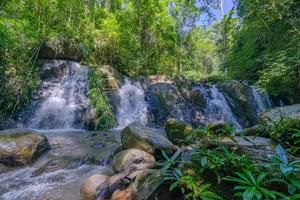 Four waterfall way in the forest in Sapun village, Nan, Thailand photo