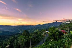 Beautiful sunset scenic with light shade into the mountain which locates in rural countryside photo